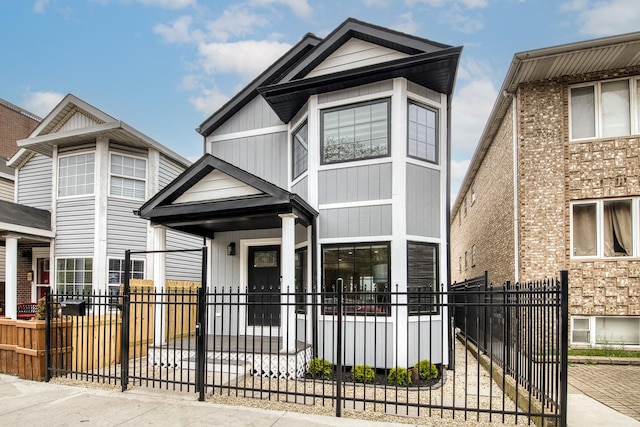 1715 S Ruble St, Chicago, IL 60616 - view of front of home with a fenced front yard, a porch, and board and batten siding