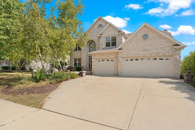 13613 Arborview Blvd, Plainfield, IL 60585 - view of front of house with concrete driveway, brick siding, and a garage