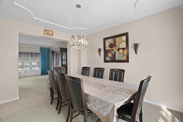 13613 Arborview Blvd, Plainfield, IL 60585 - dining area with light colored carpet, a tray ceiling, and a chandelier