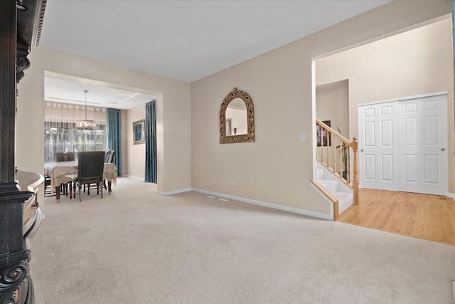 13613 Arborview Blvd, Plainfield, IL 60585 - living area featuring carpet, stairway, and a chandelier