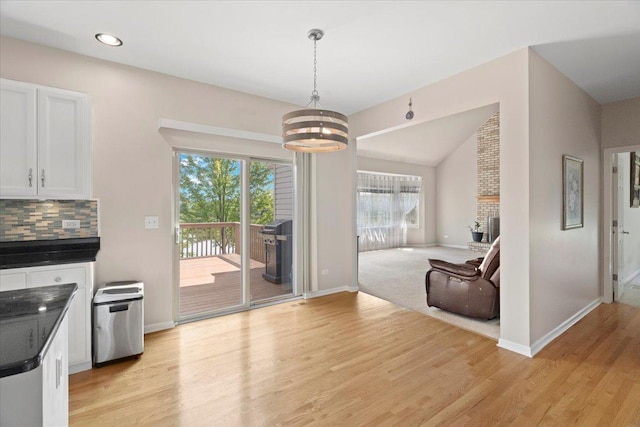 13613 Arborview Blvd, Plainfield, IL 60585 - kitchen featuring dark countertops, a fireplace, a chandelier, healthy amount of natural light, and lofted ceiling