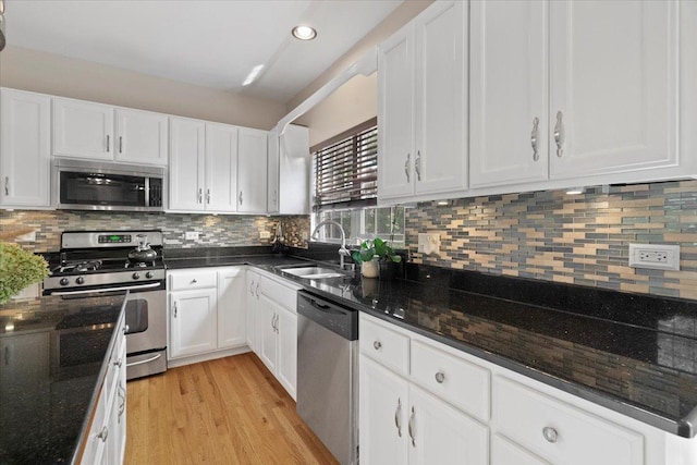 13613 Arborview Blvd, Plainfield, IL 60585 - kitchen with stainless steel appliances, white cabinets, light wood finished floors, dark stone countertops, and recessed lighting