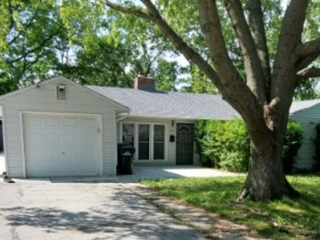 348 Niagara St, Park Forest, IL 60466 - ranch-style house with driveway, an attached garage, and a chimney