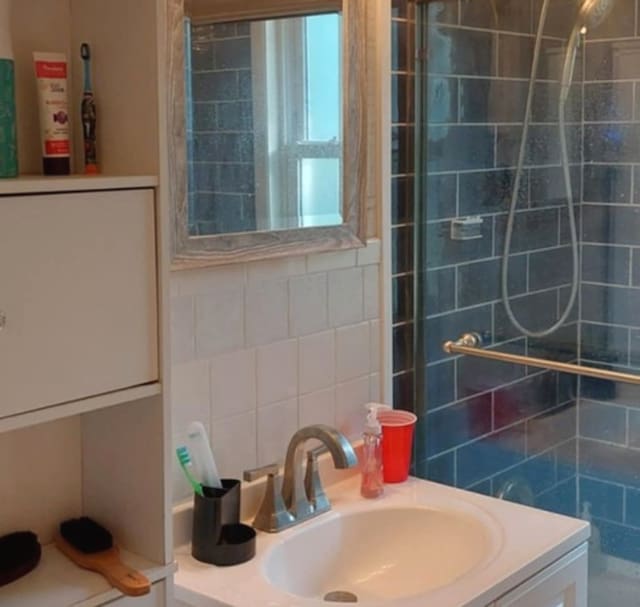 348 Niagara St, Park Forest, IL 60466 - bathroom with vanity, a tile shower, tile walls, and backsplash