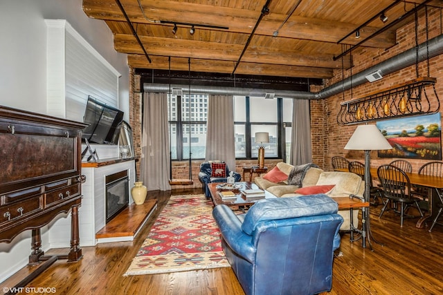 1243 S Wabash Ave Unit 302, Chicago, IL 60605 - living area featuring track lighting, wooden ceiling, brick wall, wood-type flooring, and a fireplace