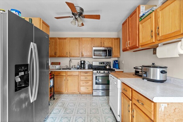 334 Idlewood Dr, Bolingbrook, IL 60440 - kitchen featuring appliances with stainless steel finishes, light countertops, a ceiling fan, a sink, and light floors