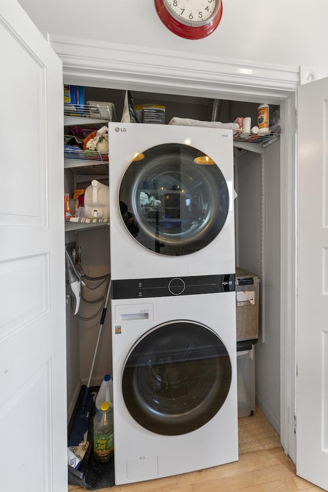 1128 W Wolfram St Unit 2, Chicago, IL 60657 - washroom featuring stacked washing machine and dryer and light wood-style floors