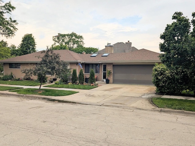 301 N Redfield Ct, Park Ridge, IL 60068 - view of front facade with a garage, concrete driveway, a front lawn, a chimney, and brick siding