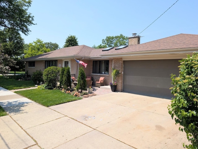 301 N Redfield Ct, Park Ridge, IL 60068 - ranch-style house with an attached garage, brick siding, concrete driveway, a front yard, and a chimney