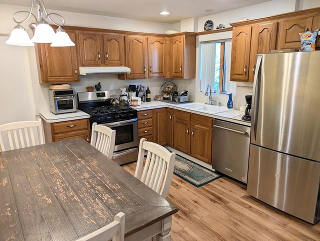 301 N Redfield Ct, Park Ridge, IL 60068 - kitchen with appliances with stainless steel finishes, brown cabinetry, under cabinet range hood, light wood-style floors, and recessed lighting