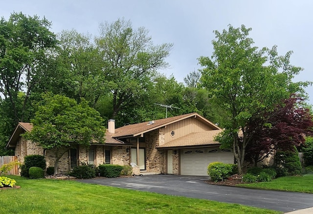 18068 Jason Ln, Lansing, IL 60438 - view of front of house with asphalt driveway, an attached garage, brick siding, and a chimney