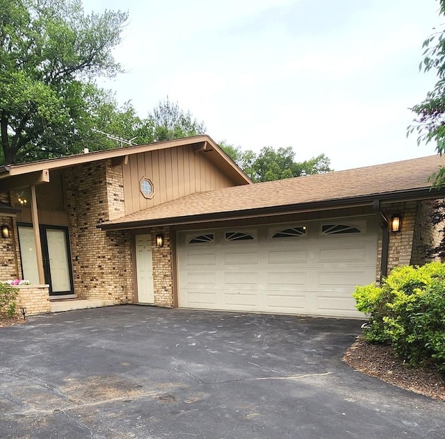 18068 Jason Ln, Lansing, IL 60438 - view of front of home featuring asphalt driveway, an attached garage, and brick siding