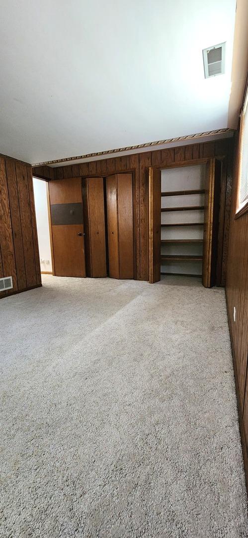18068 Jason Ln, Lansing, IL 60438 - basement with wood walls and light colored carpet