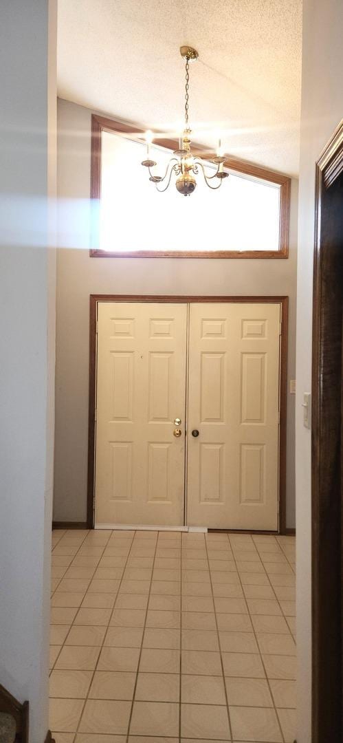 18068 Jason Ln, Lansing, IL 60438 - entryway featuring a chandelier, light tile patterned floors, and a textured ceiling