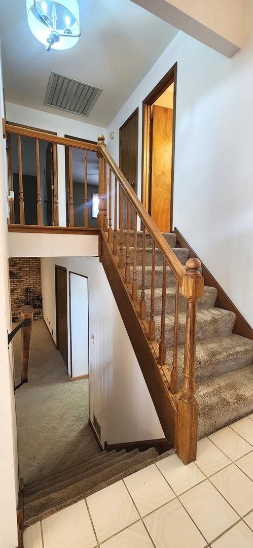 18068 Jason Ln, Lansing, IL 60438 - staircase featuring carpet and tile patterned flooring