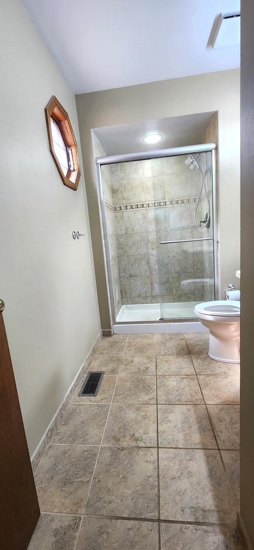 18068 Jason Ln, Lansing, IL 60438 - bathroom featuring toilet and a stall shower
