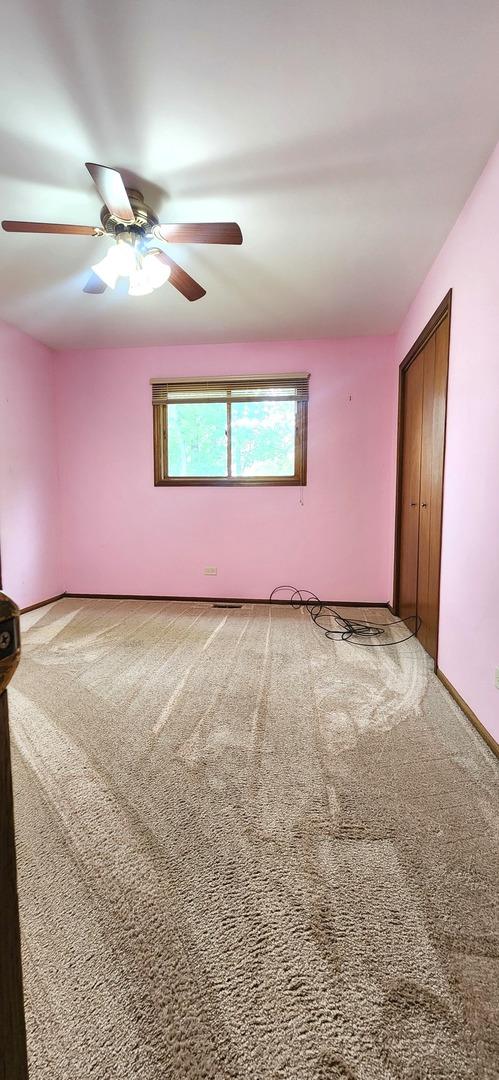 18068 Jason Ln, Lansing, IL 60438 - spare room featuring a ceiling fan and carpet floors