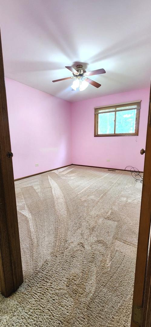 18068 Jason Ln, Lansing, IL 60438 - empty room featuring ceiling fan and carpet flooring