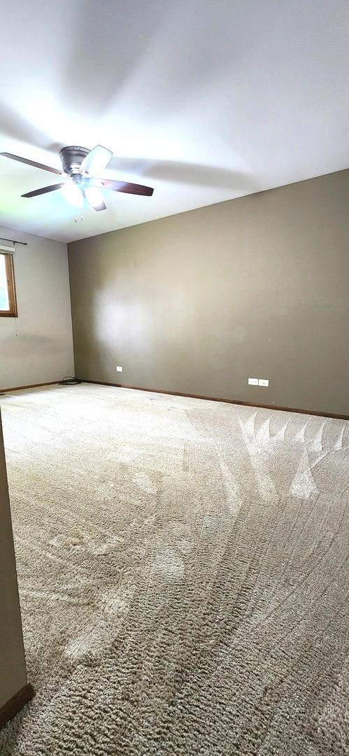 18068 Jason Ln, Lansing, IL 60438 - empty room featuring carpet floors and ceiling fan