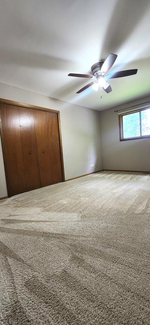 18068 Jason Ln, Lansing, IL 60438 - unfurnished bedroom with carpet, a closet, and ceiling fan