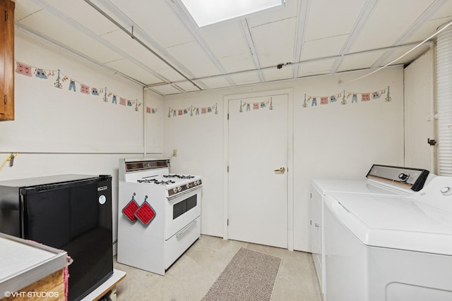 1613 Douglas St, Joliet, IL 60435 - kitchen featuring white gas stove, washer and clothes dryer, light countertops, and refrigerator