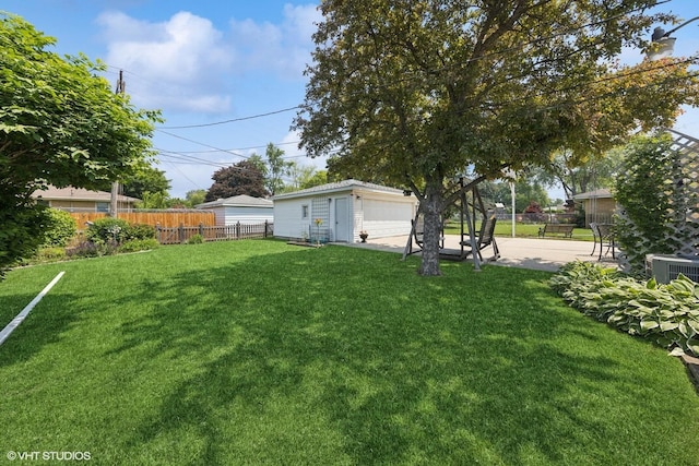 1613 Douglas St, Joliet, IL 60435 - view of yard featuring a garage, an outdoor structure, and a patio area