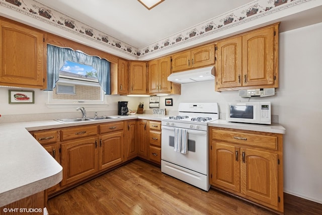 1613 Douglas St, Joliet, IL 60435 - kitchen with white appliances, under cabinet range hood, dark wood-style floors, and light countertops