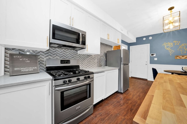 3137 N Monticello Ave, Chicago, IL 60618 - kitchen featuring appliances with stainless steel finishes, wooden counters, white cabinets, dark wood-style flooring, and wainscoting