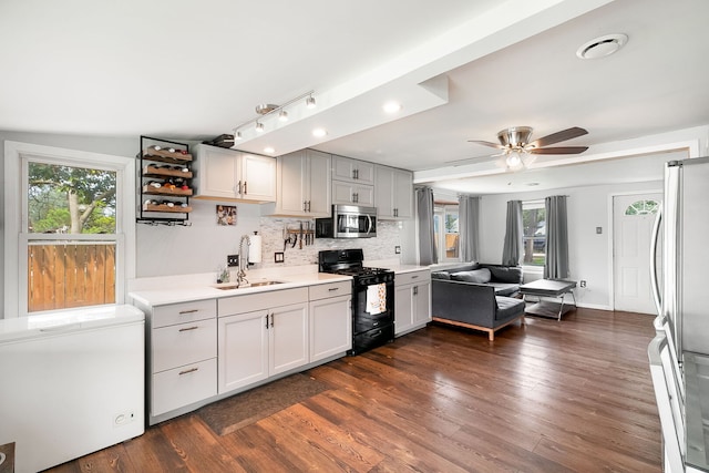 2303 Sweetbriar Ave, Crest Hill, IL 60403 - kitchen featuring a sink, stainless steel appliances, light countertops, tasteful backsplash, and plenty of natural light