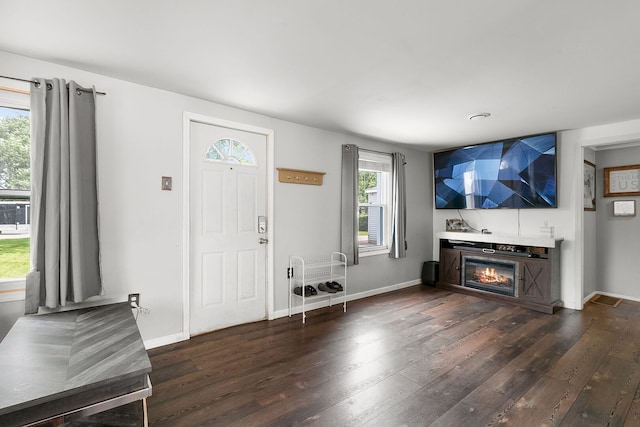 2303 Sweetbriar Ave, Crest Hill, IL 60403 - entrance foyer featuring dark wood-type flooring, a glass covered fireplace, and baseboards