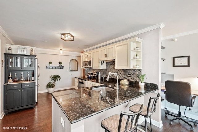 2 E Erie St Unit 2114, Chicago, IL 60611 - kitchen with cream cabinetry, a sink, stainless steel appliances, crown molding, and open shelves