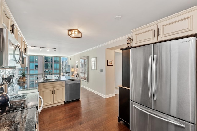 2 E Erie St Unit 2114, Chicago, IL 60611 - kitchen with stainless steel appliances, cream cabinets, baseboards, a sink, and dark wood-type flooring