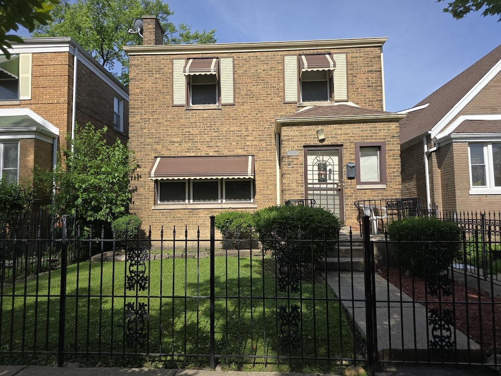 8518 S Seeley Ave, Chicago, IL 60620 - view of front facade featuring brick siding, a chimney, and a fenced front yard