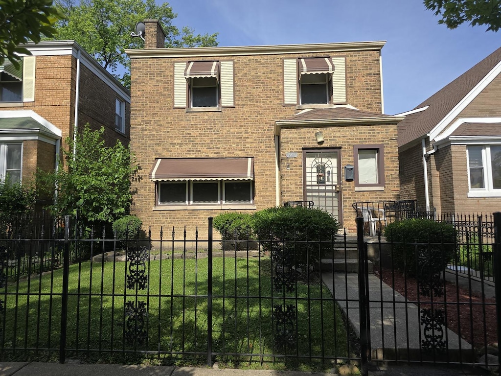8518 S Seeley Ave, Chicago, IL 60620 - view of front of property featuring brick siding, a chimney, and a fenced front yard