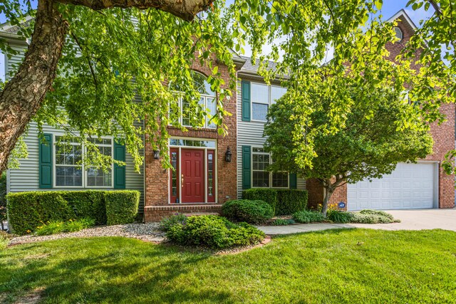 3208 Countrybend Ln, Champaign, IL 61822 - view of front of house featuring concrete driveway, brick siding, and a front yard