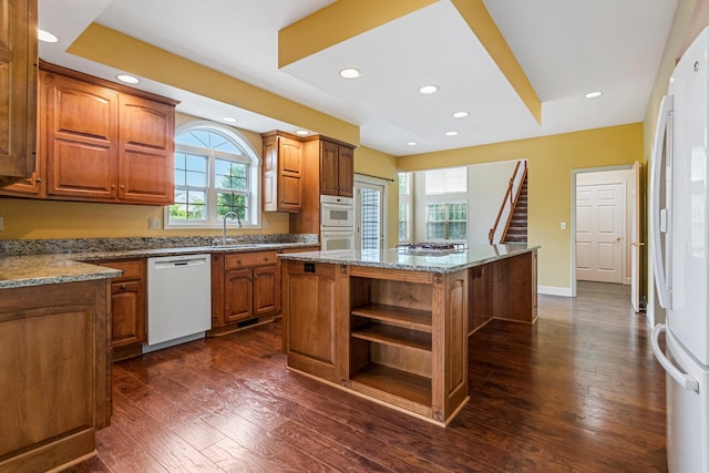 3208 Countrybend Ln, Champaign, IL 61822 - kitchen with white appliances, open shelves, a center island, healthy amount of natural light, and recessed lighting