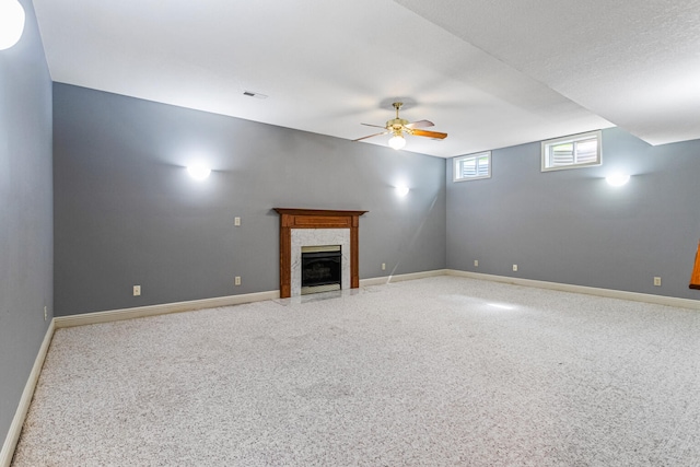 3208 Countrybend Ln, Champaign, IL 61822 - unfurnished living room with a premium fireplace, a ceiling fan, and carpet floors