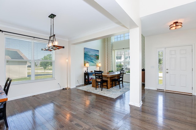 662 Kentshire Dr, Yorkville, IL 60560 - foyer with dark wood-type flooring, ornamental molding, and a chandelier