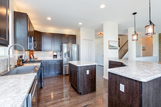 662 Kentshire Dr, Yorkville, IL 60560 - kitchen with stainless steel appliances, dark brown cabinetry, dark wood-style floors, tasteful backsplash, and a kitchen island