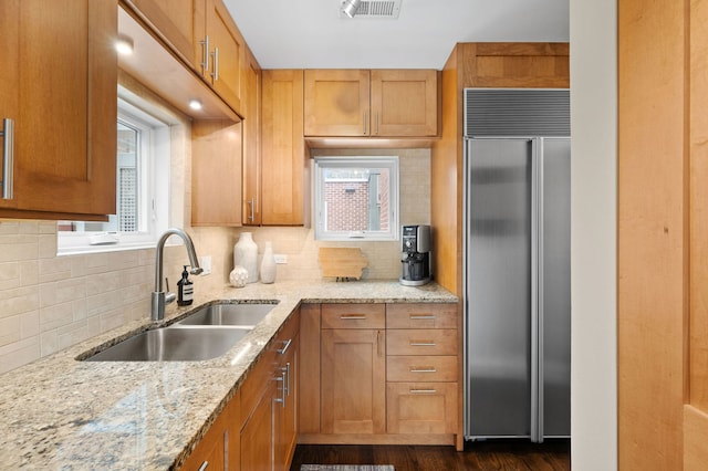 2757 N Wayne Ave Unit E, Chicago, IL 60614 - kitchen featuring high quality fridge, a sink, backsplash, and brown cabinets