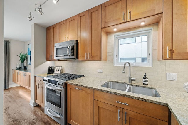 2757 N Wayne Ave Unit E, Chicago, IL 60614 - kitchen featuring appliances with stainless steel finishes, a sink, tasteful backsplash, and light stone counters