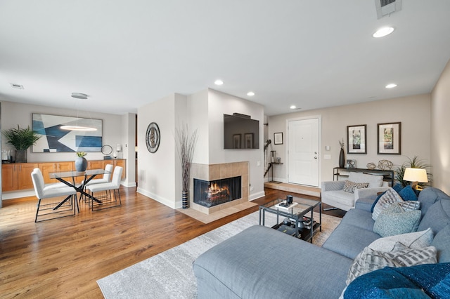 2757 N Wayne Ave Unit E, Chicago, IL 60614 - living area with a tile fireplace, wood finished floors, recessed lighting, and baseboards