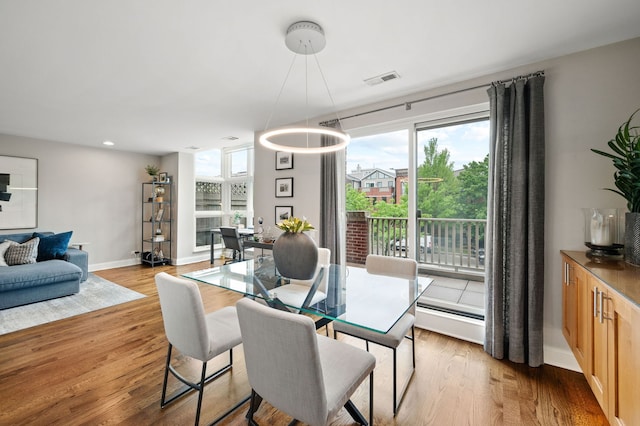 2757 N Wayne Ave Unit E, Chicago, IL 60614 - dining area featuring baseboard heating, light wood-style floors, baseboards, and recessed lighting