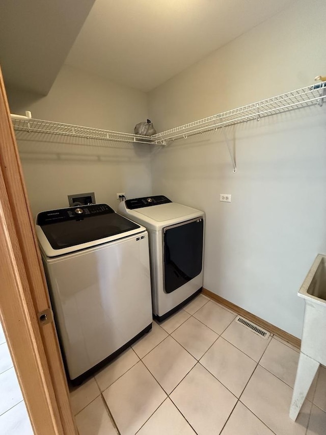 8020 Latrobe Ave, Burbank, IL 60459 - laundry area featuring independent washer and dryer and light tile patterned floors