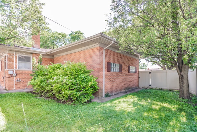 2519 Sunnyside Ave, Westchester, IL 60154 - view of side of home featuring a chimney, brick siding, and a gate