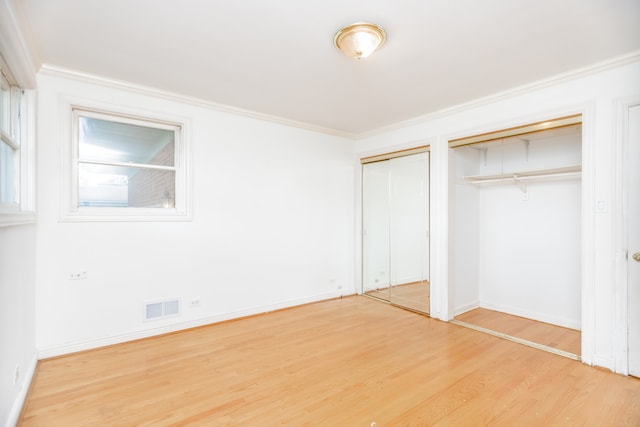 2519 Sunnyside Ave, Westchester, IL 60154 - unfurnished bedroom featuring multiple closets, wood finished floors, and crown molding