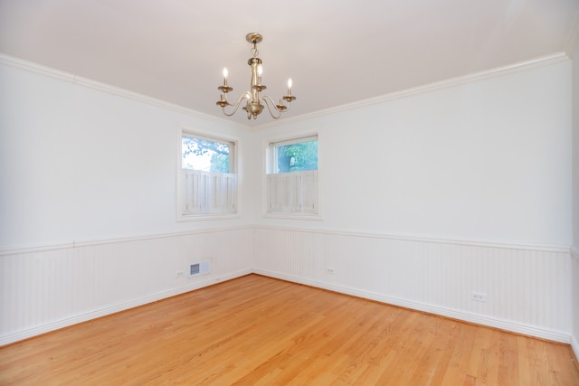 2519 Sunnyside Ave, Westchester, IL 60154 - empty room featuring a chandelier, wood finished floors, a wainscoted wall, and ornamental molding