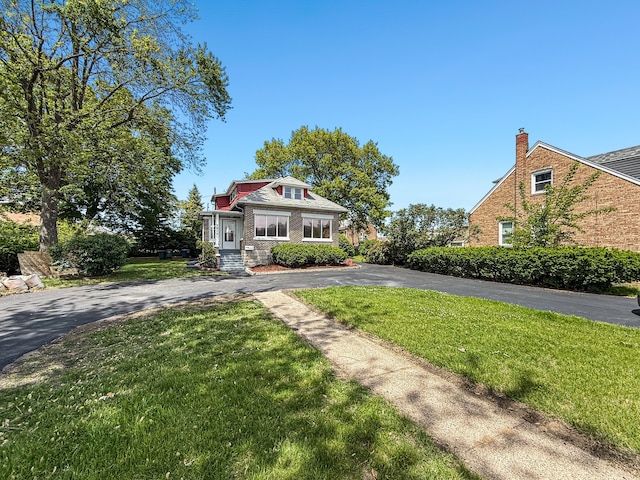 2914 Ridge Rd, Lansing, IL 60438 - view of front facade featuring a front yard, driveway, a chimney, and brick siding