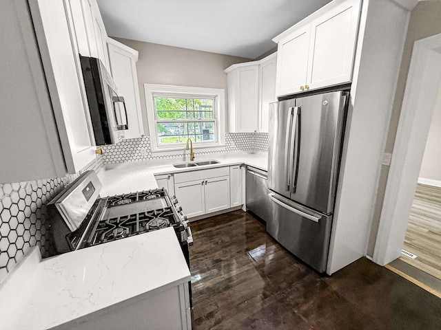 2914 Ridge Rd, Lansing, IL 60438 - kitchen with stainless steel appliances, dark wood-style flooring, decorative backsplash, light countertops, and white cabinets