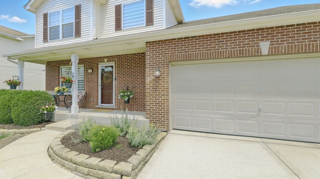 5321 Meadowbrook St, Plainfield, IL 60586 - entrance to property featuring brick siding, covered porch, concrete driveway, and a garage